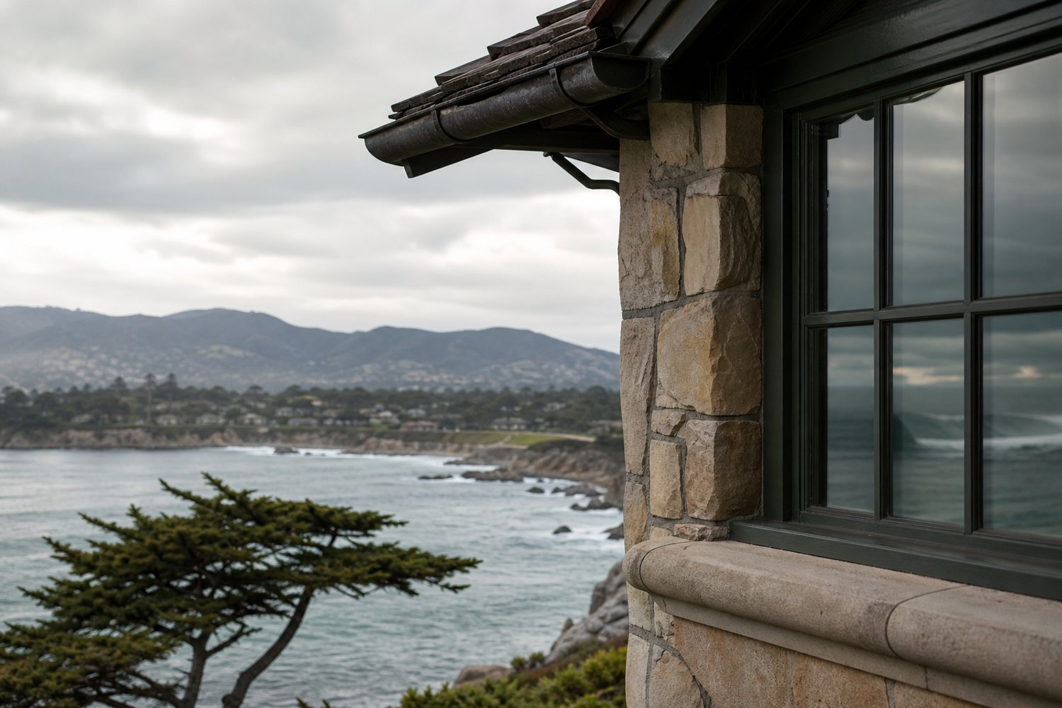 A close view of the exterior detail on a house, with the water in view in Pebble Beach, CA — Oceanfront Property in Pebble Beach